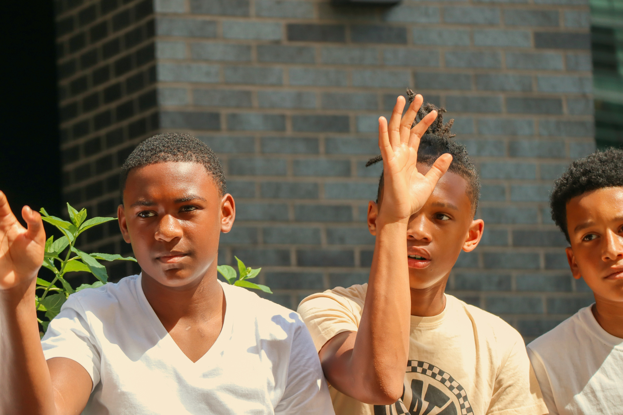 Young festivalgoers wave to the camera at DMV SummerJam