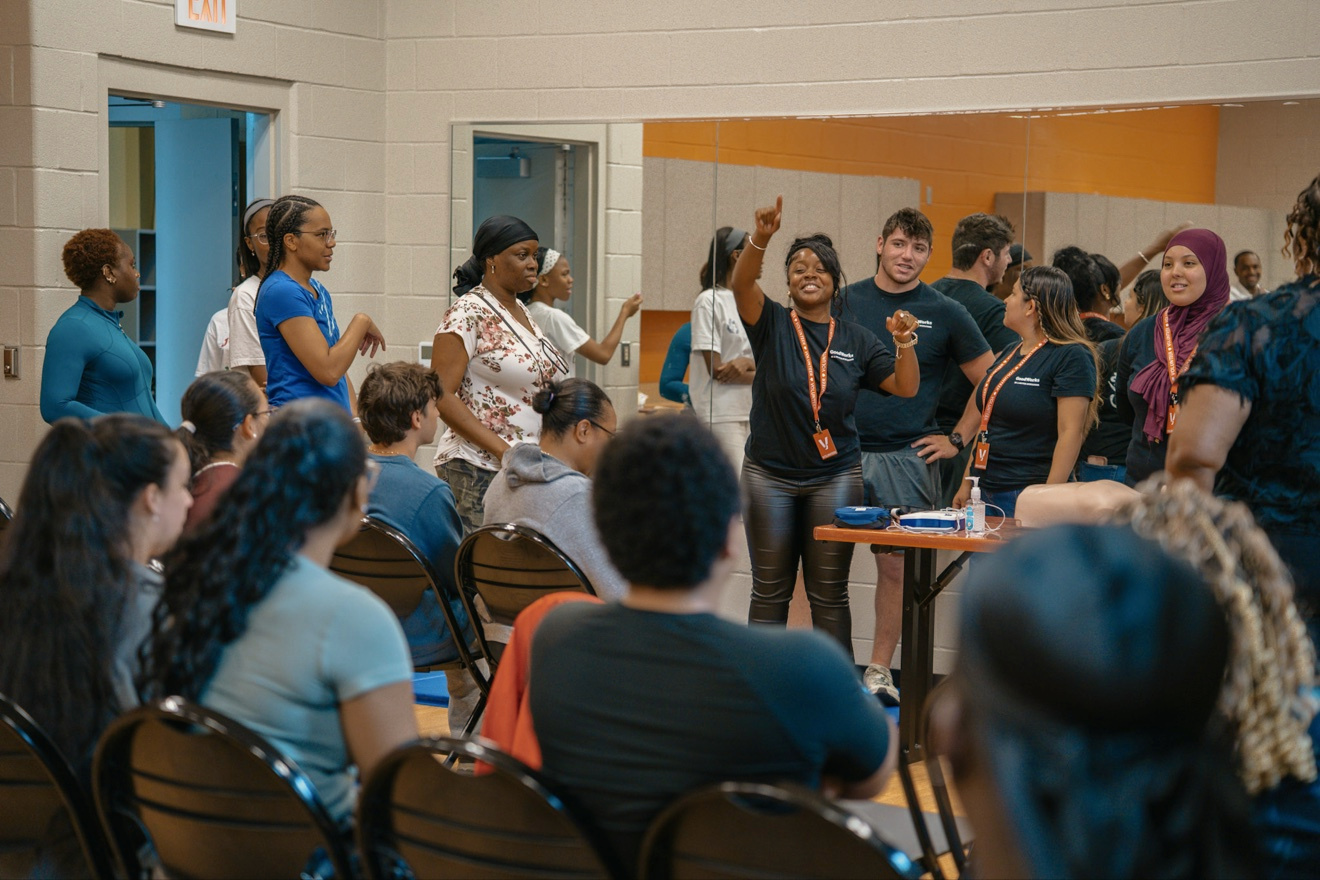 A GoodWorks instructor leads an interactive group demonstration at First Aid Palooza