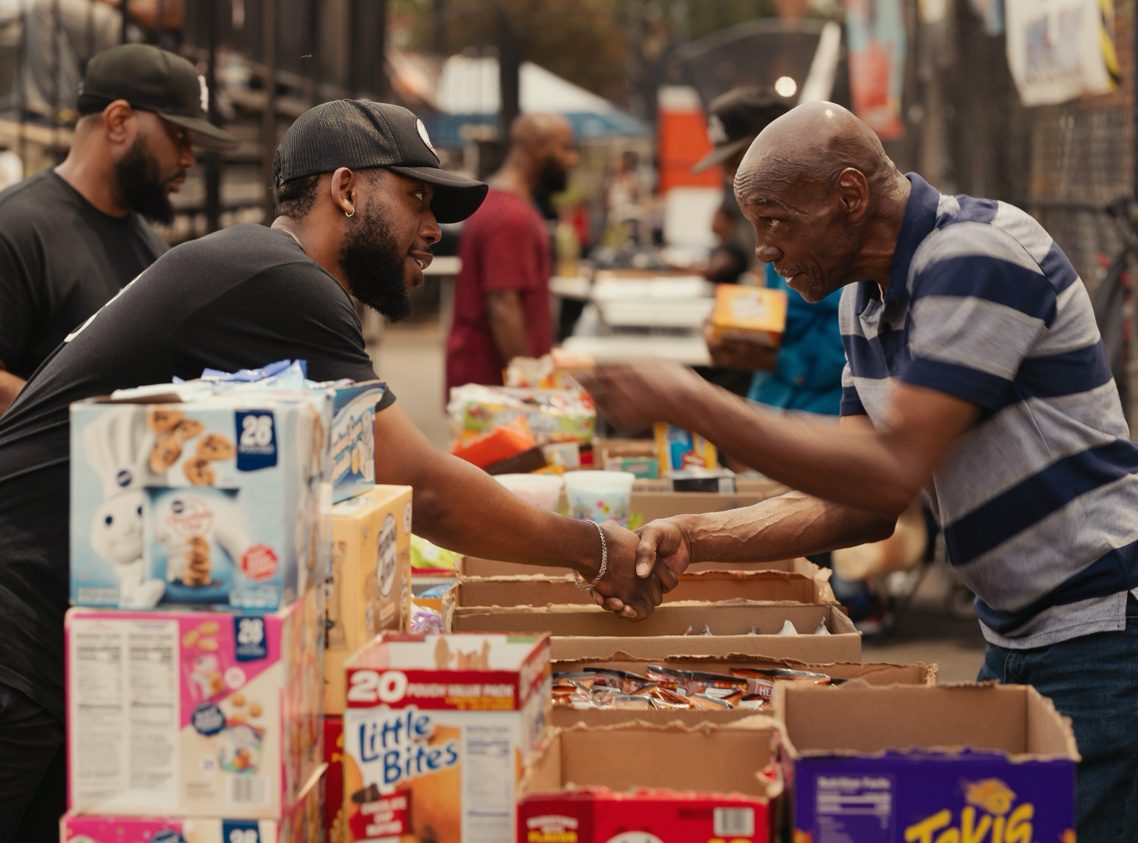 GoodWorks volunteers hand out food and supplies to neighbors at a community giveaway