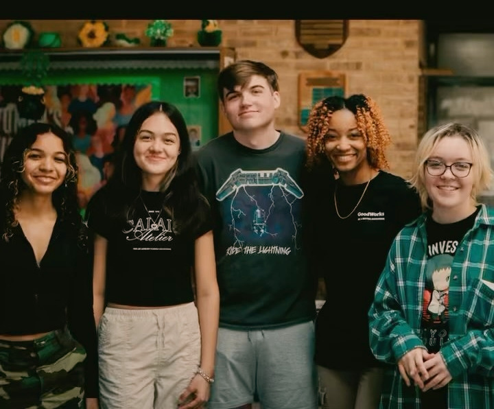 Five participants smile together after a GoodWorks community workshop