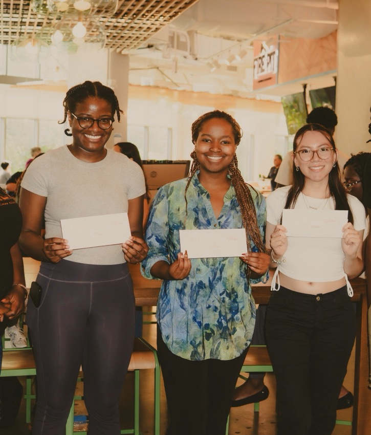 Three young participants proudly hold their lifesaving certification cards after a GoodWorks class