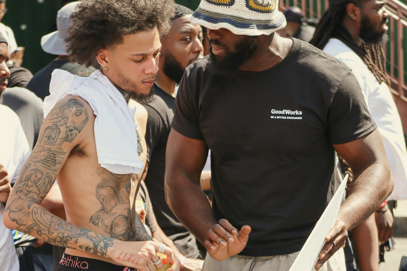 A community member practices emergency response with a GoodWorks volunteer