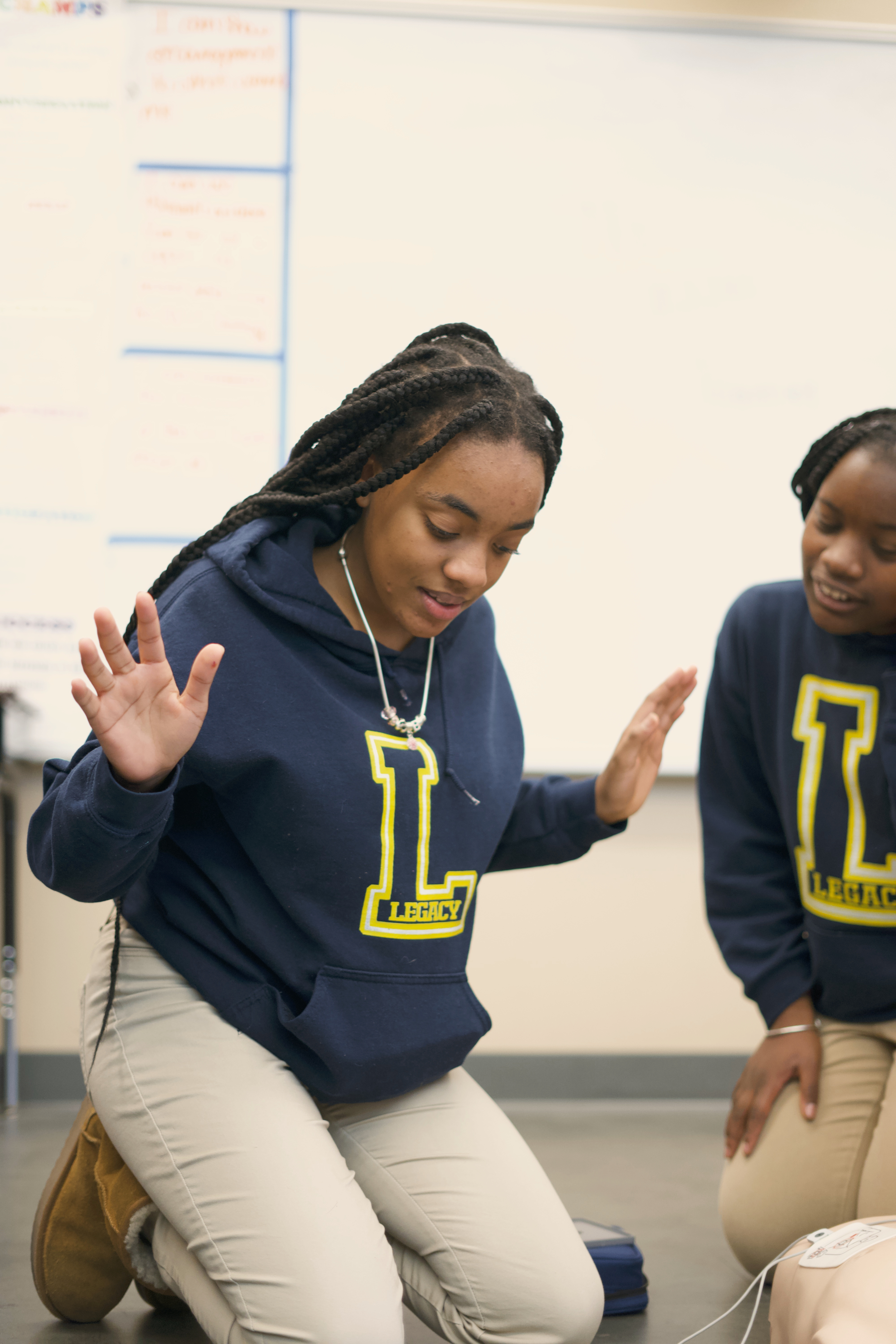 Two students practice emergency response together during a GoodWorks training