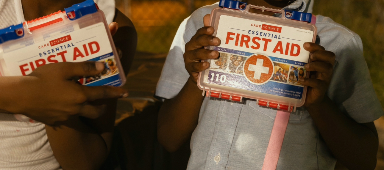 Young community members show their GoodWorks first aid kits