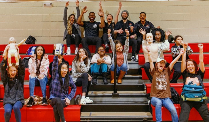 Girls Inc. participants and the GoodWorks team celebrate a lifesaving skills workshop together